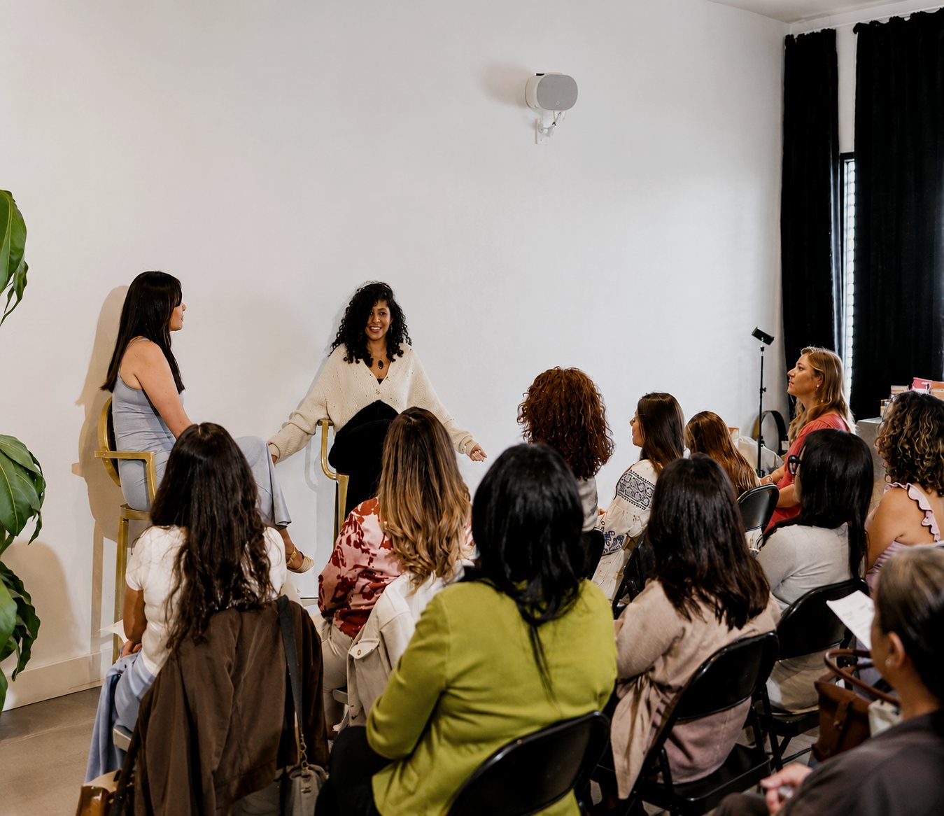 Tania speaking to a room of women at an event